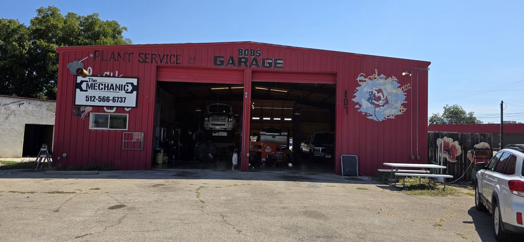 The Mechanic's red barn shop with two open bays on West 10th Street, Lampasas